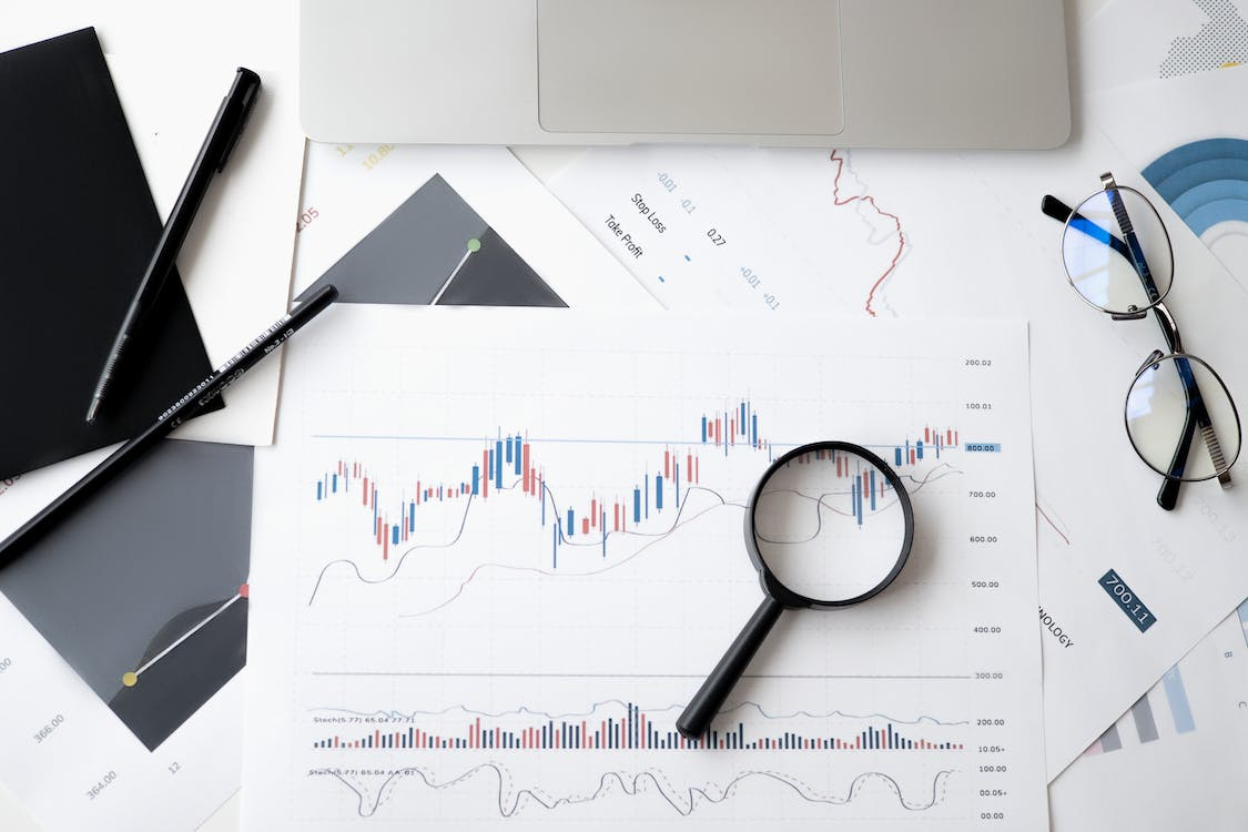 A magnifying glass placed on top of a financial document symbolizing the importance of analyzing cash flow details.