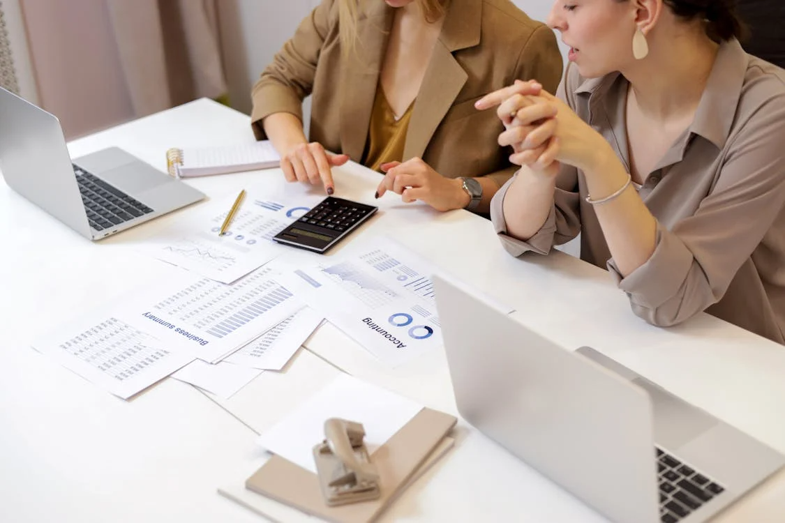 An image of two women discussing accounting and growth strategy