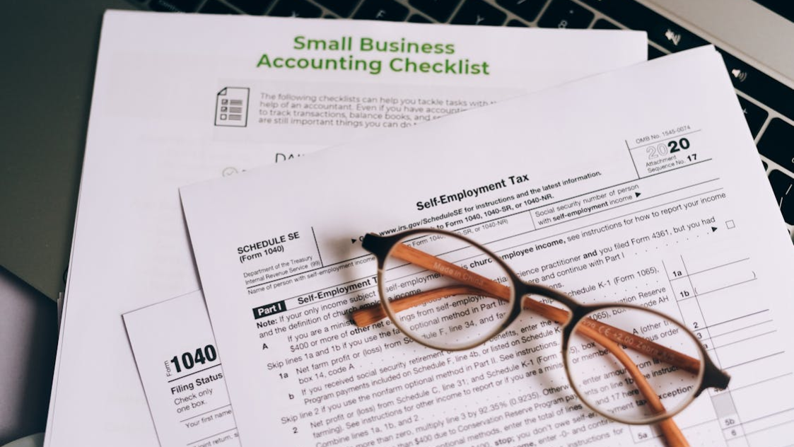 close up of checklist and forms with glasses on top