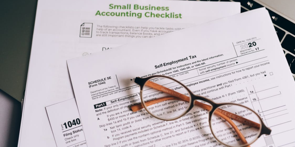 close up of checklist and forms with glasses on top